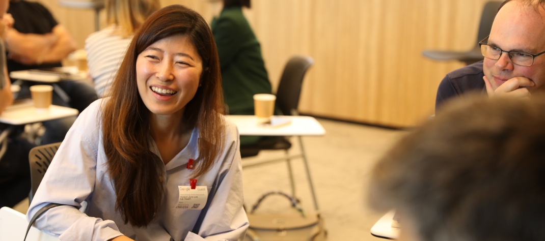 A woman looking at something and smiling.