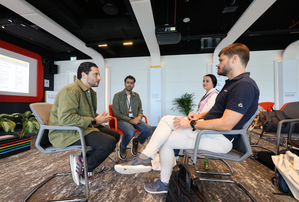 Four individuals are actively participating in a discussion.