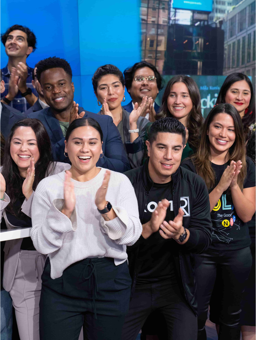 A group of people clapping and smiling.