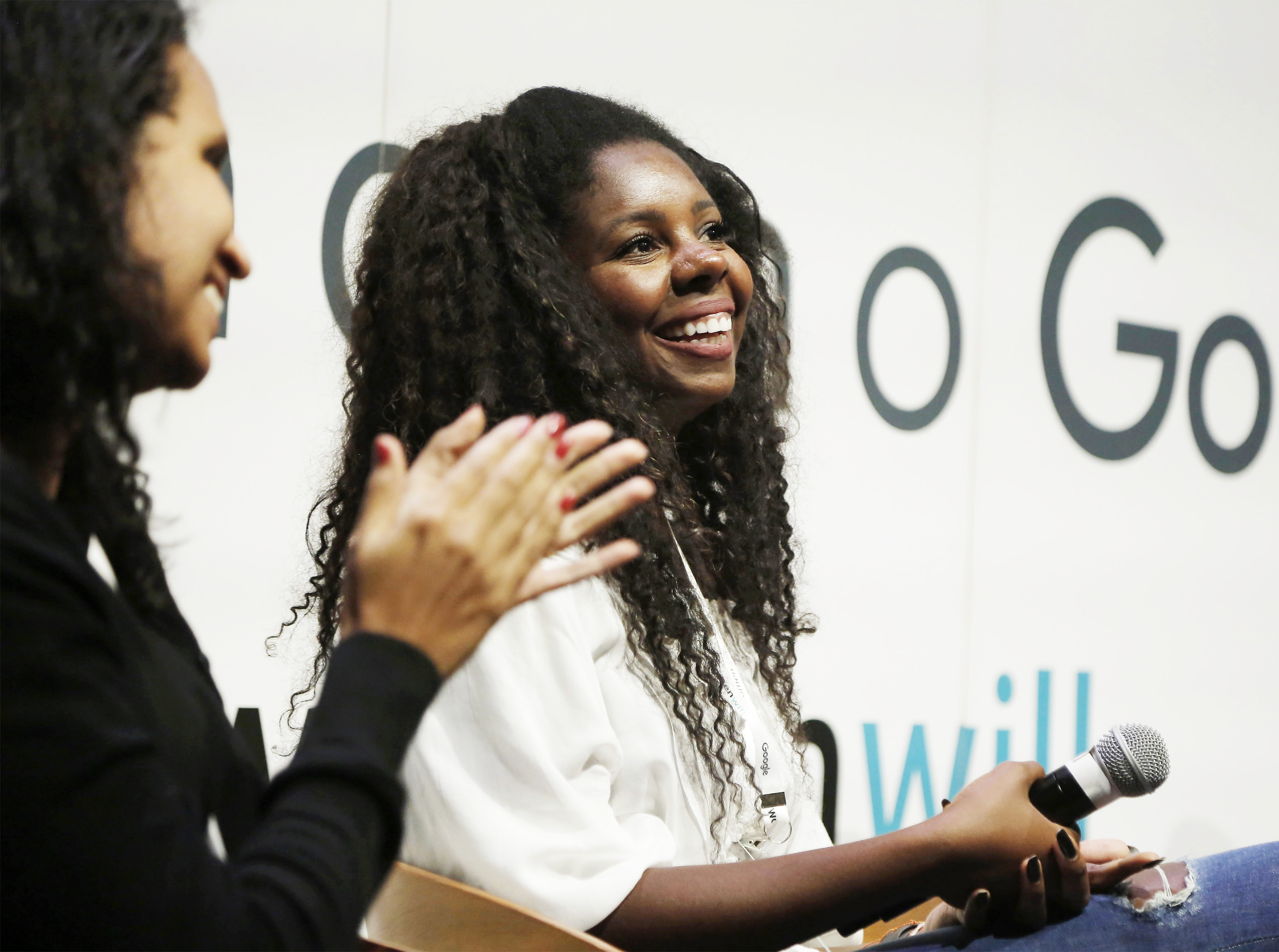 Two women smiling and clapping.